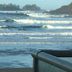 Cobble Wood and Bird Sanctuary Guest Houses in Tofino with ocean waves and a beachfront railing
