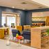 Sonesta Select Boston Foxborough Mansfield lobby lounge with bar seating and colorful chairs in Foxborough