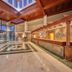 Sandos Papagayo Beach Resort lobby in Playa Blanca with wood ceiling, marble floor, and stone reception