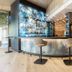 Heilthermen Resort Bad Waltersdorf lobby bar with curved counter, high stools and illuminated shelves in Bad Waltersdorf