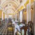 Hotel Ambica Empire, Chennai: ornate dining hall with set tables, arched ceiling and patterned floor