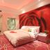 Longwan Hotel (Foshan Ceramics City) guest room in Foshan with rose mural wall and pink lighting