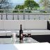 Weserlounge Hotel Garni in Hessisch Oldendorf terrace seating with wine glasses and river view
