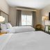 Fairfield by Marriott Inn & Suites Sandusky guest room with two beds, desk, and wall-mounted TV