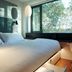 citizenM Rome Isola Tiberina guest room with bed, window seat and city views in Rome