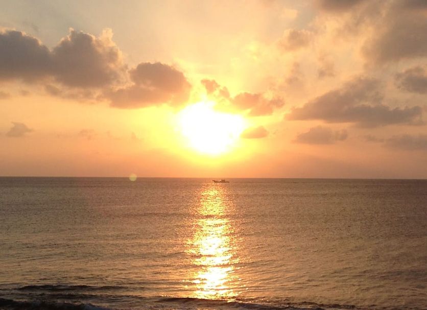 Sunset ocean view at El Sol Town Okinawa in Chatan with golden reflection on calm water