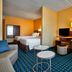Fairfield Inn by Marriott Myrtle Beach Broadway at the Beach guest room with bed, desk, TV and seating area