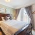 Newton Villa in Brampton bedroom with queen bed, nightstands, curtains, and balcony doors