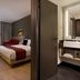 Citadines Arnulfpark Munich in Munich: modern guest room with bed, desk, seating area and bathroom vanity