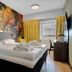 Thon Hotel Saga Haugesund guest room with floral mural, double bed, desk and window view