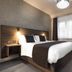 Qudos Salisbury guest room with double bed, window seat, and armchair