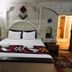 Seven Rock Cave Hotel in Göreme cave-style room with a double bed and colorful woven blanket