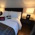 Home Edge Accommodations @ Tivoli Garden Residences Manila bedroom with queen bed and bedside lamps