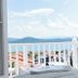 Cunda Piano Otel in Ayvalik balcony view with sea, distant hills, and a table set with cups