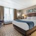 Comfort Inn & Suites Glen Mills - West Chester guest room with king bed, desk, and large window