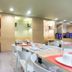 City Résidence Paris Saint-Maurice breakfast room with white tables and chairs under recessed lights