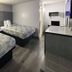 Motel 6 Meridian Ms room with two beds, desk, and TV in Meridian