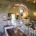 EcoResort Il Cantico della Natura in Magione: rustic stone dining room with white tables and chairs