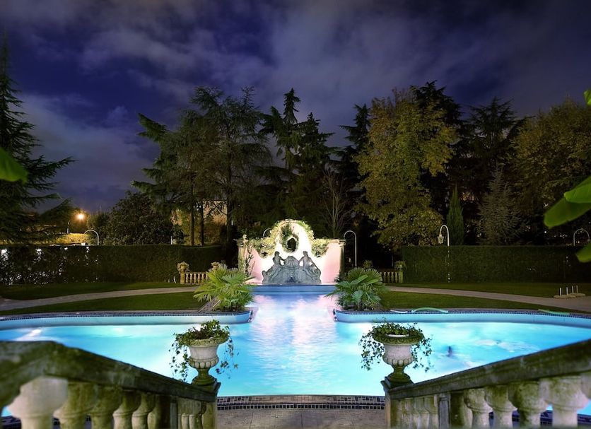 Night pool view at Abano Ritz Hotel Terme in Abano Terme with lit garden and fountain backdrop