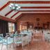 Afrique Boutique Hotel O.R. Tambo in Boksburg dining room with brick walls, chandeliers and set tables