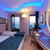 Grand Zaman Beach Hotel Alanya guest room with twin beds, balcony sea view, and illuminated ceiling