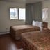 Murphy's Alaskan Inn in Seward: guest room with two beds, windows, and a small lamp