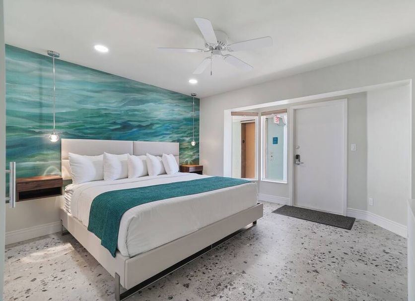 Bridgewalk, a Landmark Resort in Bradenton Beach: bright bedroom with ocean-themed mural and king bed