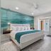 Bridgewalk, a Landmark Resort in Bradenton Beach: bright bedroom with ocean-themed mural and king bed
