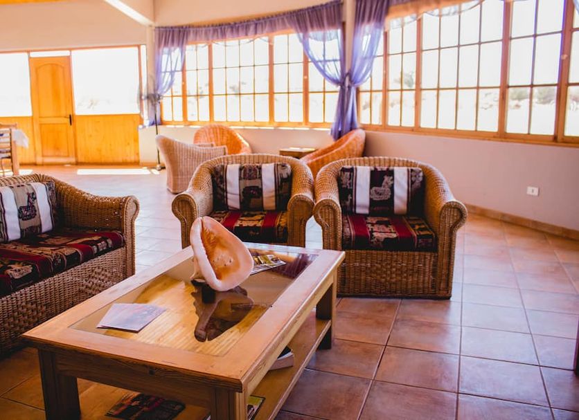 Hotel Iorana Tolache in San Pedro de Atacama lounge with wicker seating and large windows