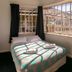 Kiwi's Nest Budget Accommodation & Backpackers, Dunedin: bedroom with bed by large window