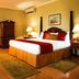 Seagarden Beach Resort room in Montego Bay with king bed, wood furniture, and warm lighting