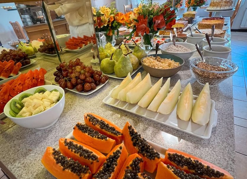 Pousada Vovó Carolina in Gramado breakfast buffet with fresh fruit, cheese, and cereal