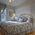 Auberge Marquis de Montcalm room in Sherbrooke with a bed, armchair, window, and bedside lamp