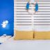 Gesher Haziv Travelhotel in Nahariyya: blue-and-white bedroom with life preserver wall decor