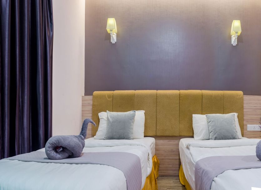 Gm Grand Moments Bandar Sunway in Subang Jaya: twin beds with rolled towels in a guest room