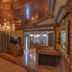 The Victoria Bed & Breakfast in Bentonville: ornate wood-paneled guest room with chandelier and sitting area