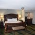 Wingate by Wyndham Baltimore BWI Airport in Linthicum Heights guest room with king bed, lamps, and bench