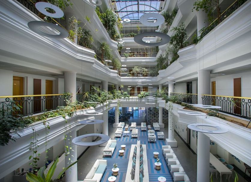 Anastasia Waterpark Beach Resort in Protaras atrium with indoor pool, balconies and lush greenery