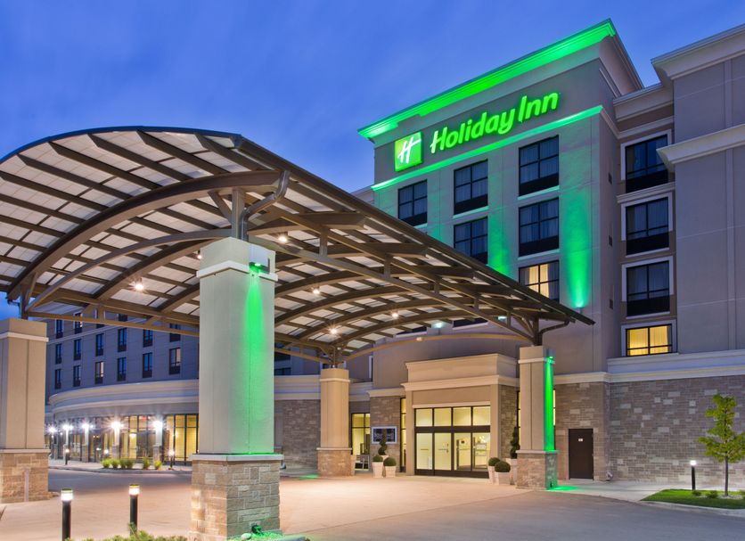 Holiday Inn & Suites Red Deer South by IHG entrance with covered drop-off and green-lit facade