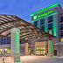 Holiday Inn & Suites Red Deer South by IHG entrance with covered drop-off and green-lit facade
