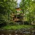 Woodstock Way Hotel in Woodstock, wooded riverside cabin with balcony above a rocky creek