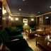 Hilton Frankfurt Gravenbruch lounge in Neu Isenburg with leather sofas, green chairs and warm lighting