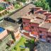 Velinn Pousada Canoa Ilhabela in Ilhabela, seen from above with terracotta-roofed buildings and lush greenery.