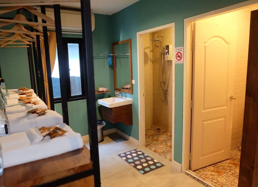 Siri Poshtel Bangkok in Bangkok bathroom with shared sink area, shower stall and towel station