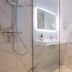 Hôtel Les Pins - Oléron bathroom with walk-in shower, backlit mirror and towel radiator in Saint-Trojan-les-Bains