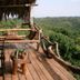 Crater Forest Tented Camp in Karatu: rustic tented deck with chairs and forest valley views