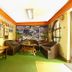 Pilgrims Guest House Kathmandu lounge with seating, green carpet, and mountain mural