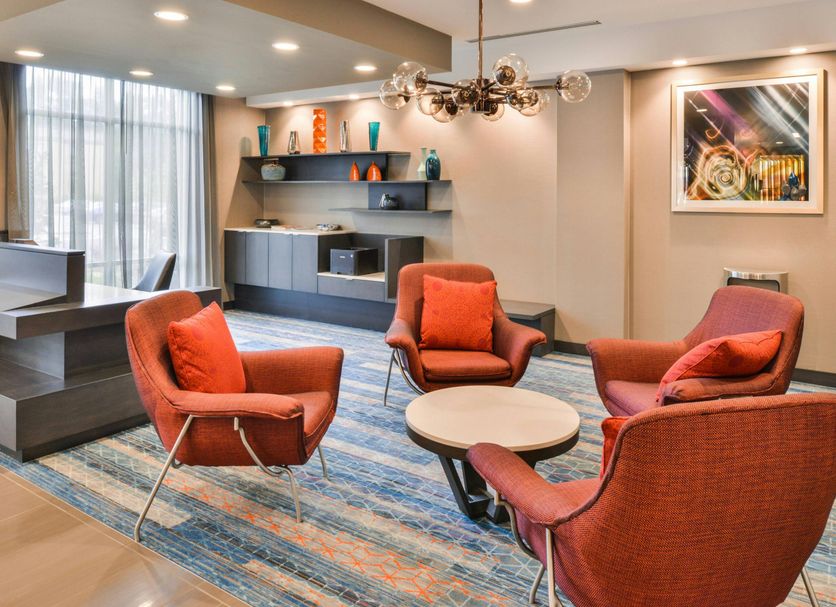 Fairfield Inn and Suites by Marriott Raleigh Cary lobby seating area with orange chairs and modern decor