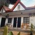 El Taraw Bed And Breakfast in Puerto Princesa with A-frame roof, patio seating, and garden