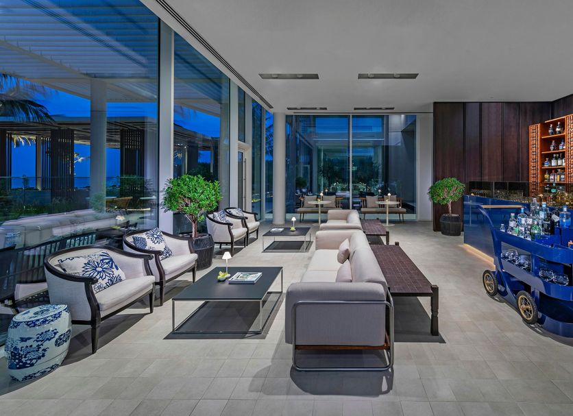Al Zorah Beach Resort in Ajman lobby lounge with seating and blue bar area
